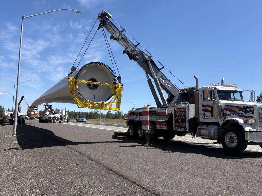 Eastern Oregon Towing Peterbilt boom truck lifting a wind turbine component